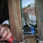 Alan suits up and squeezes by the sampson posts to work on the forward bulkhead.